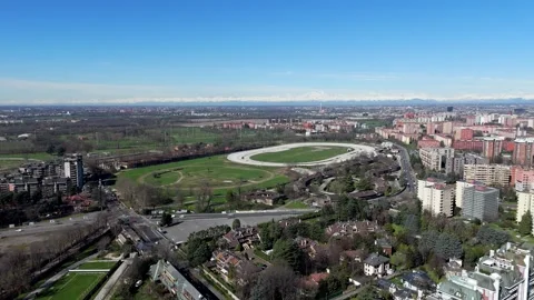 Aerial drone view of Milan’s La Mura racecourse with surrounding mountains Stock Footage 321669955