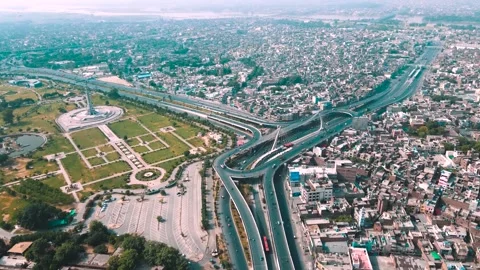 Aerial drone view of Minar-e-Pakistan and the modern Azadi Flyover interchan Stock Footage 346321952