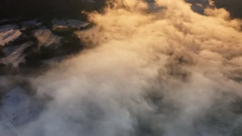 Aerial drone view of mist in a valley on a cold winters day with snow and Stock Footage 230997121