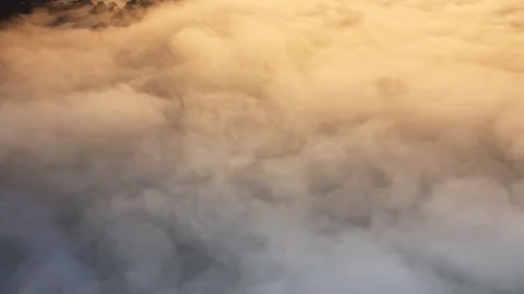 Aerial drone view of mist in a valley on a cold winters day with snow and Stock Footage 243440452