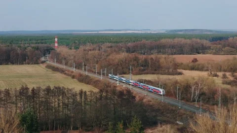 Aerial drone view of modern double-deck passenger train passing through 스톡 동영상 331097413
