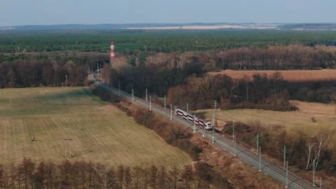 Aerial drone view of modern double-deck passenger train passing through Stock Footage 331097416