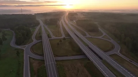 Aerial Drone View of Modern Highway Interchange at Sunrise in Misty Countryside 스톡 동영상 344598293