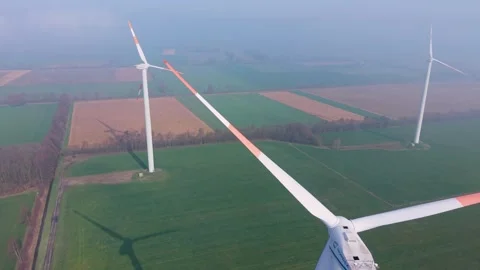 Aerial drone view of modern wind turbines in a rural agricultural landscape. Stockbeeldmateriaal 332022123