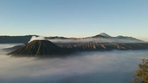 Aerial drone view of Mount Bromo in the morning with a sea of ​​clouds Stock Footage 250480513