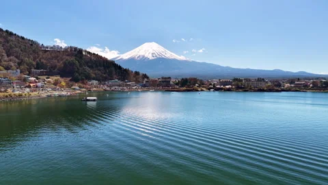 Aerial drone view of Mount Fuji with its snow-capped cone rising above the calm Stock Footage 344977755