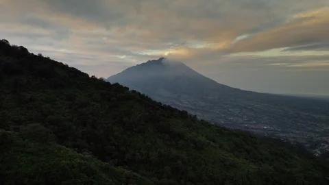 Aerial drone view of Mount Merapi volcano, Central Java, Indonesia, at sunrise Stock Footage 319999157
