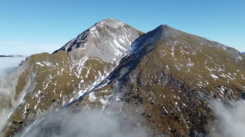 Aerial Drone View of Mount Stol in Slovenia on a Sunny Day with Snow Patches Stock Footage 328984954