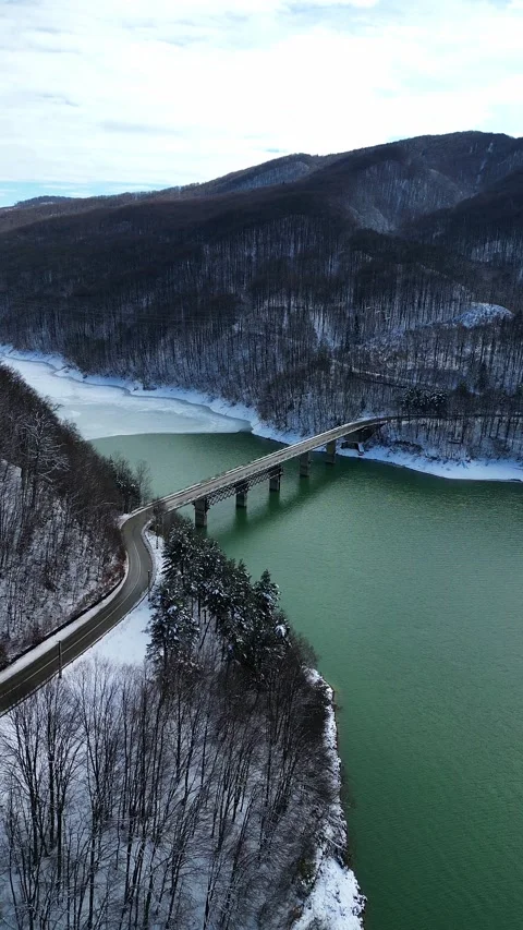 Aerial Drone View of Mountain Bridge Over Partially Frozen Lake Stock Footage 330240296