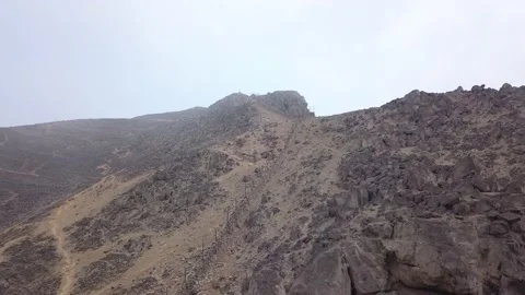 Aerial drone view of a mountain divided by a wall on a foggy day Stock Footage 145083289