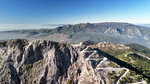 Aerial Drone View of Mountain Road Leading to a Summit Observation Tower Stock Footage 340096268