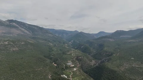 Aerial drone view of mountain valley with winding road and green hills Stock-Footage 331072541