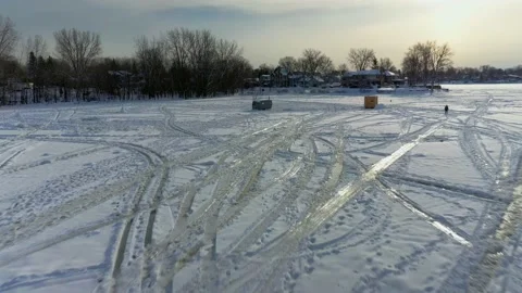 Aerial drone view moving backwards over the tracks left in the snow Stock-Footage 164345605