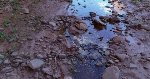 Aerial drone view of a muddy riverbed and boulders in Capitol Reef Stock Footage 95604250
