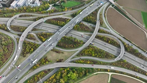 Aerial drone view of a multi-level highway intersection with moving cars Stock Footage 240763954