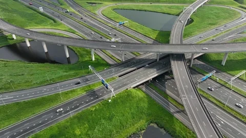 Aerial drone view of a multi-level highway intersection with moving cars Stock Footage 278467100