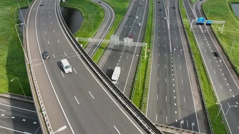 Aerial drone view of a multi-level highway intersection with moving cars Stock Footage 284305835