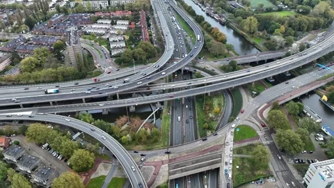 Aerial drone view of a multi-level highway intersection with moving cars Stock Footage 293670368