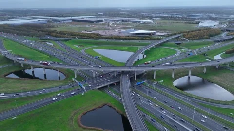 Aerial drone view of a multi-level highway intersection with moving cars Stock Footage 303939945