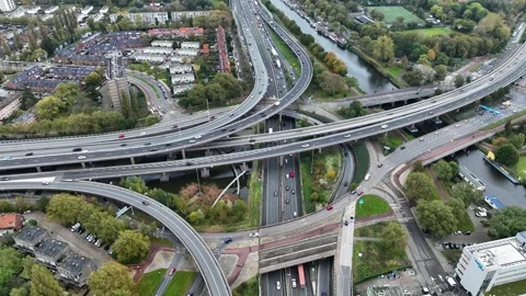 Aerial drone view of a multi-level highway intersection with moving cars Stock Footage 324848134