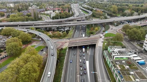 Aerial drone view of a multi-level highway intersection with moving cars Stock Footage 327774676