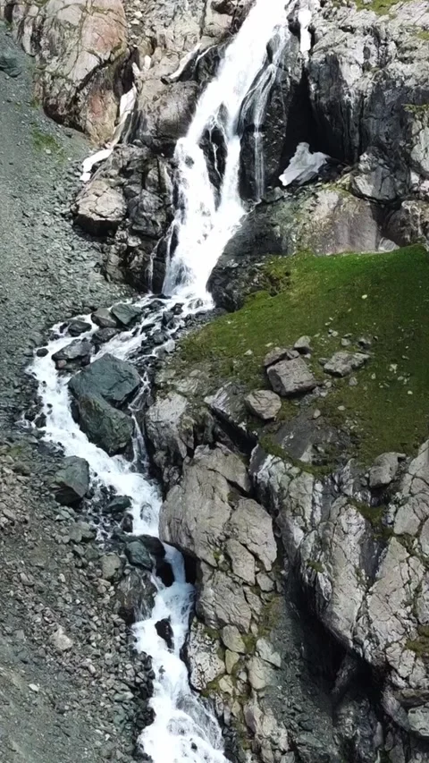 Aerial drone view of multi-tiered mountain waterfall cascading through gorge 스톡 동영상 336686603