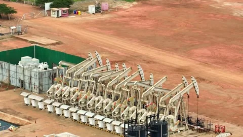 Aerial drone view of multiple oil pumpjacks operating in a vast field. Stock Footage 331280231