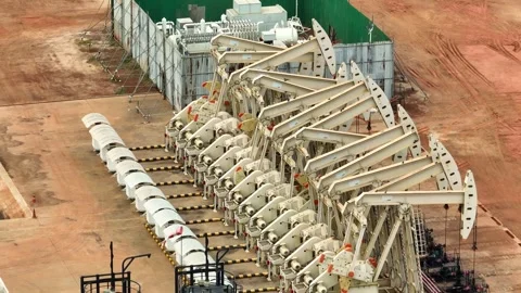 Aerial drone view of multiple oil pumpjacks operating in a vast field. Stock Footage 331280242