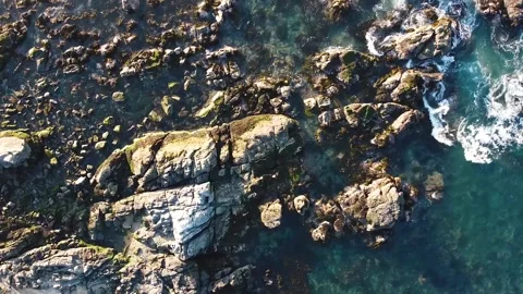 Aerial drone view of ocean waves crashing on rocks Stock Footage 149133954