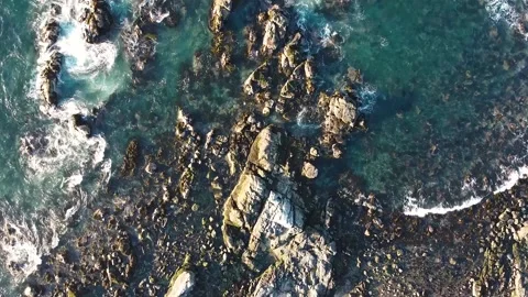 Aerial drone view of ocean waves crashing on rocks on  Pacific Coast Stock Footage 149134002