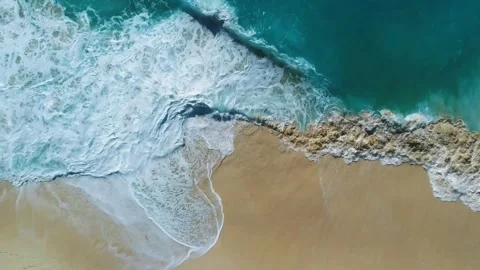 Aerial Drone View of Ocean Waves Crashing on Sandy Beach Stock Footage 308640837