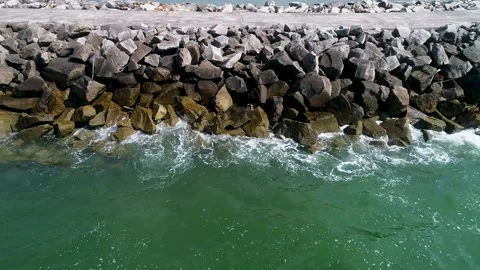 Aerial drone view of ocean waves breaking on a breakwater Stock Footage 308647314