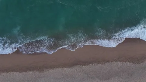Aerial Drone View of Ocean Waves Crashing on Sandy Beach Stock Footage 319861113