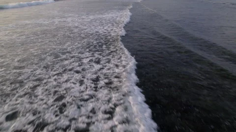 Aerial drone view of ocean waves at sunset Stock Footage 319995594