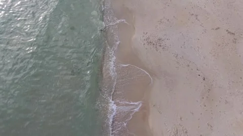 Aerial drone view of ocean waves crashing on sandy beach Video stock 321047184