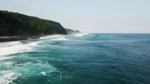 Aerial Drone View of Ocean Waves Rolling Along Tropical Coastline Stock Footage 326094602