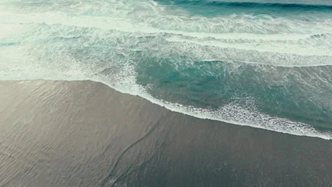 Aerial drone view of ocean waves rolling onto Pacific Beach shoreline Video stock 339252467