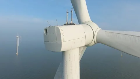 Aerial drone view of offshore wind turbines in the sea covered in thick fog. Stock Footage 336978077