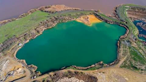 Aerial drone view of open pit dredging lake in a abandoned gravel mine Stock Photos