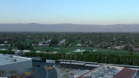 Aerial drone view orbit of golf course and vacation homes in Palm Springs Stock-Footage 231271199