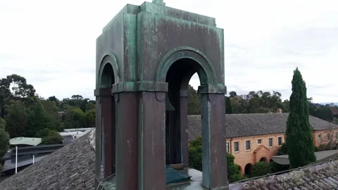 Aerial drone view orbiting a historic copper bell tower Stockbeeldmateriaal 336713636