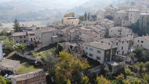 Aerial drone view over an ancient village with city walls and a tower. Stock Footage 113200644