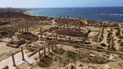 Aerial drone view over the ancient ruins of Sabratha, Libya, showing remains of Stock Footage 321858465