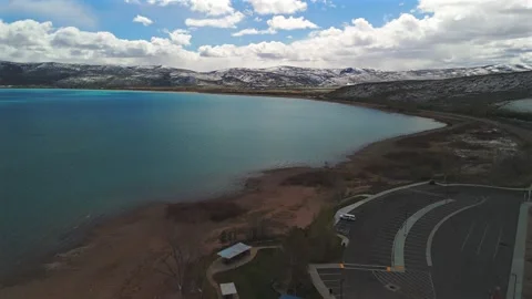Aerial drone view over Bear Lake Utah with curved sandy shoreline Stock Footage 335080690