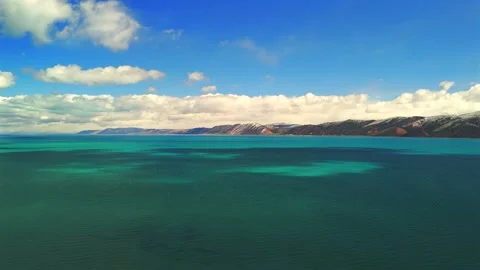 Aerial drone view over Bear Lake Utah with turquoise water and cloudscape Stock Footage 335080699