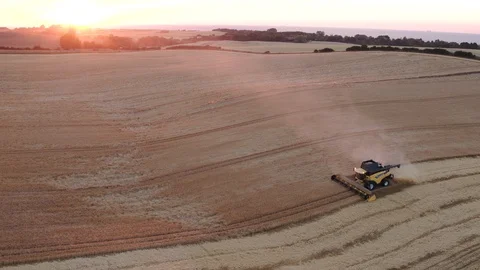 Aerial drone view over Combine Harvester at sunset Vídeo Stock 109620979