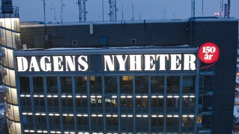 Aerial drone view over DN Newspaper building in Stockholm in winter at night 動画素材 109484960