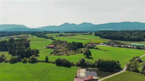Aerial drone view over green farmland and meadows near Petting in Bavaria Stock Footage 346494277
