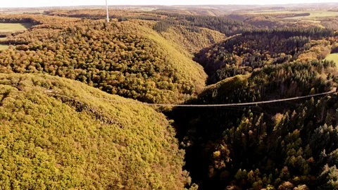 Aerial Drone View over a large hanging suspension bridge in golden Autumn 스톡 동영상 122374837