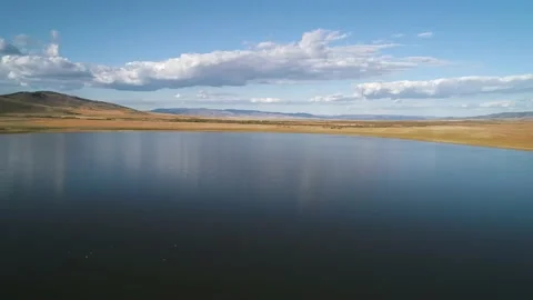 Aerial drone view over sunset lake. Beautiful peaceful sunset lake reflection Stock Footage 234581773